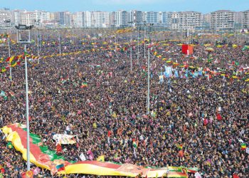 Kurds wave flags as they as they gather to celebrate Newroz, the Kurdish New Year, in the southeastern Turkish city of Diyarbakir, on March 21, 2015. Newroz, which means "new day" in Kurdish and marks the first day of Spring, is also celebrated in Iran, Afghanistan, Azerbaijan, Albania, Bahrain, Georgia, Turkmenistan, Tajikistan, Uzbekistan, Kyrgyzstan and Kazakhstan, as well as among various other Iranian and Turkic peoples in Iraqi Kurdistan, Syria, Lebanon, Pakistan, India, northwestern China, the Caucasus, the Crimea, and the Balkans. AFP PHOTO / ILYAS AKENGIN