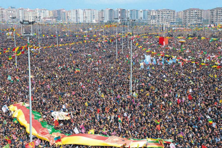 Kurds wave flags as they as they gather to celebrate Newroz, the Kurdish New Year, in the southeastern Turkish city of Diyarbakir, on March 21, 2015. Newroz, which means "new day" in Kurdish and marks the first day of Spring, is also celebrated in Iran, Afghanistan, Azerbaijan, Albania, Bahrain, Georgia, Turkmenistan, Tajikistan, Uzbekistan, Kyrgyzstan and Kazakhstan, as well as among various other Iranian and Turkic peoples in Iraqi Kurdistan, Syria, Lebanon, Pakistan, India, northwestern China, the Caucasus, the Crimea, and the Balkans. AFP PHOTO / ILYAS AKENGIN